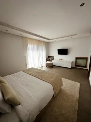 a bedroom with a large bed and a television at Luxury Villa 4 Bedrooms with Big Pool 5km from Medina in Marrakech