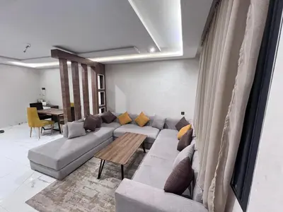 a living room with a couch and a table at Appartement chic & elegant in Marrakech