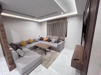a living room with a couch and a table at Appartement chic & elegant in Marrakech