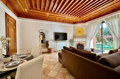 a living room with a couch and a table at Sunny apartment in Palmeraie with Pools and Gardens in Marrakech