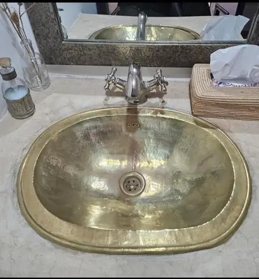 a bathroom sink with a silver faucet on a counter at Riad Awel Oasis Privée au coeur de la Medina in Marrakech