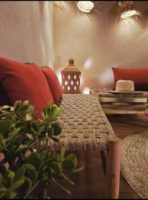 a room with a couch and a table with a lamp at Riad Awel Oasis Privée au coeur de la Medina in Marrakech