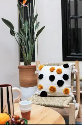 a cow pillow sitting on a chair in a room at Riad Awel Oasis Privée au coeur de la Medina in Marrakech