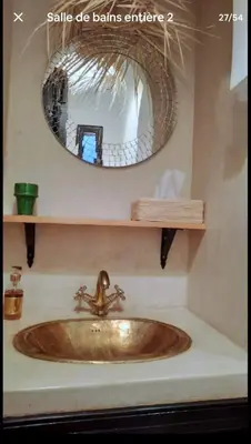 a sink in a bathroom with a mirror at Riad Awel Oasis Privée au coeur de la Medina in Marrakech