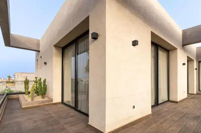 a house with large glass windows on a balcony at Villa NAYA in Marrakech
