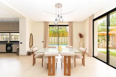 a dining room with a table and chairs at Villa NAYA in Marrakech