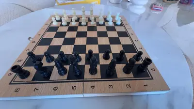 a chess board on a white table with a chessboard at Marrakech Luxury Apartment with Pool & gym in Marrakech