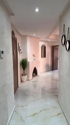 a large hallway with a tile floor and a fireplace at Marrakech Luxury Apartment with Pool & gym in Marrakech