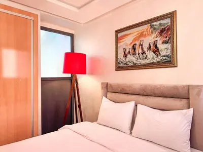 a bedroom with a bed and a red lamp at Central Apartment in Gueliz Steps from Carré Eden in Marrakech