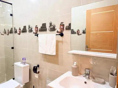 a bathroom with a sink and a toilet and a mirror at Central Apartment in Gueliz Steps from Carré Eden in Marrakech