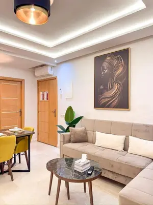 a living room with a couch and a table at Central Apartment in Gueliz Steps from Carré Eden in Marrakech