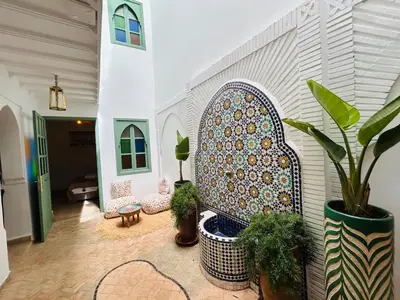 a living room with a moroccan tile wall at Riad Hami in Marrakech