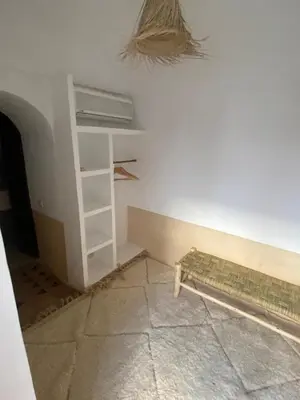 a room with a white wall and a shelf at Riad Elena l Private Riad with heated Pool in Marrakech l 3 rooms in Marrakech