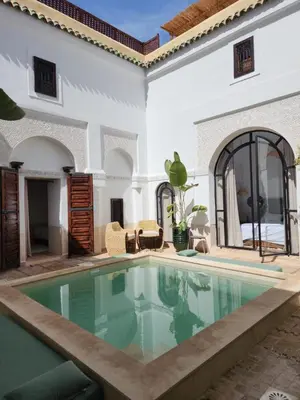 a swimming pool in the middle of a house at Riad Elena l Private Riad with heated Pool in Marrakech l 3 rooms in Marrakech