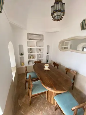 a dining room with a wooden table and chairs at Riad Elena l Private Riad with heated Pool in Marrakech l 3 rooms in Marrakech