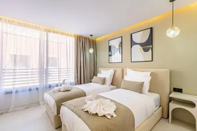 a bedroom with two beds and a large window at Luxury apartment near to McDonald's in Marrakech