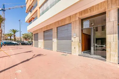 a building with two garage doors on the side of it at Luxury apartment near to McDonald's in Marrakech