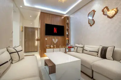 a living room with two couches and a tv at Titrit Apartment Marrakech in Marrakech