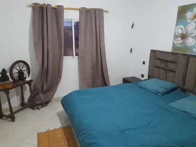 a bedroom with a blue bed and a window at Marrakech en toute simplicité in Marrakech