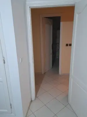 an empty hallway with a door and a tile floor at Marrakech en toute simplicité in Marrakech