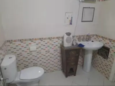a bathroom with a toilet and a sink at Marrakech en toute simplicité in Marrakech