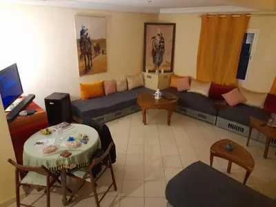 a living room with a couch and a table at Marrakech en toute simplicité in Marrakech
