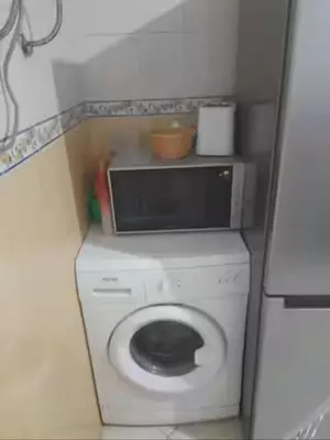 a small bathroom with a washing machine and a microwave at Marrakech en toute simplicité in Marrakech