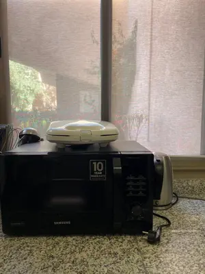 a microwave with a phone on top of it at Prestigia jade in Marrakech