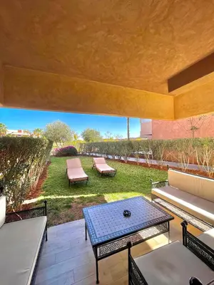 a patio with couches and a table and chairs at Prestigia jade in Marrakech
