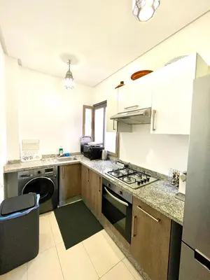 a kitchen with a sink and a stove top oven at Prestigia jade in Marrakech