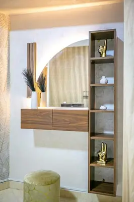 a shelf in a living room with a stool at Stylish Apartment in Gueliz by Train & Majorelle in Marrakech