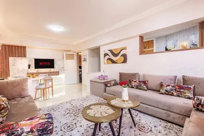 a living room with a couch and a table at Stylish Apartment in Gueliz by Train & Majorelle in Marrakech