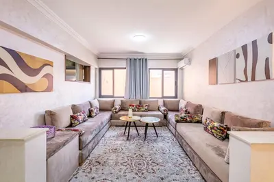 a living room with a couch and a table at Stylish Apartment in Gueliz by Train & Majorelle in Marrakech