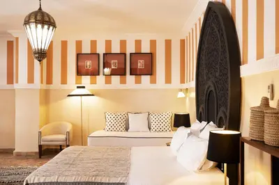 a hotel room with a bed and a chair at Riad RK Suites & Spa in Marrakech