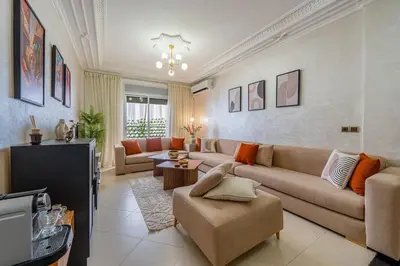 a living room with a couch and a table at Cozy apartment, 2 bedrooms, 10 min from airport and Medina in Marrakech
