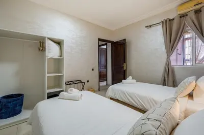 a bedroom with two beds and a window at Cozy apartment, 2 bedrooms, 10 min from airport and Medina in Marrakech