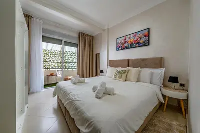 a bedroom with a large bed with stuffed animals on it at Cozy apartment, 2 bedrooms, 10 min from airport and Medina in Marrakech