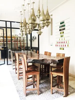 a dining room with a wooden table and chairs at Riad 144 in Marrakech