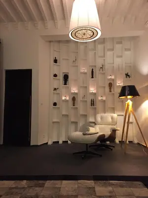 a room with a chair and a table and a lamp at Riad 144 in Marrakech