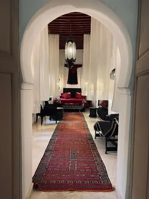 a living room with a red couch and a red rug at Riad 144 in Marrakech