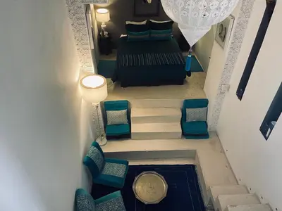an overhead view of a bedroom with a bed and chairs at Riad 144 in Marrakech