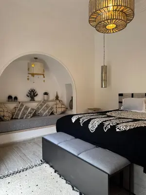 a bedroom with a large bed and a chandelier at Villa en centre Ville de Marrakech, 5 Chambres, Piscine, Rooftop in Marrakech