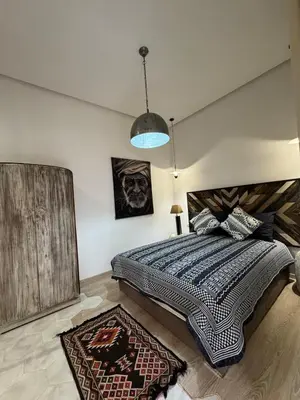 a bedroom with a large bed and a blue light at Villa en centre Ville de Marrakech, 5 Chambres, Piscine, Rooftop in Marrakech