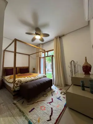 a bedroom with a bed and a ceiling fan at Villa en centre Ville de Marrakech, 5 Chambres, Piscine, Rooftop in Marrakech