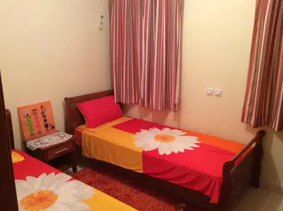 a bedroom with two beds with flowers on them at Apartment Majdoline in Marrakech