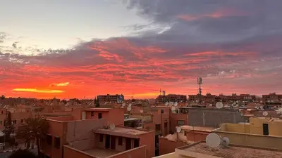 a view of a city with a sunset at KueerLand Home for All kueer Travelers in Marrakech