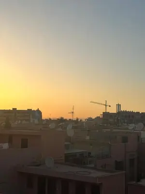 a view of a city at sunset with buildings at KueerLand Home for All kueer Travelers in Marrakech