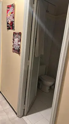 a bathroom with a refrigerator and a toilet at KueerLand Home for All kueer Travelers in Marrakech