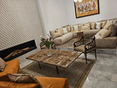 a living room with a couch and a table at Riad Dar Lghizlane in Marrakech