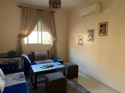a living room with a couch and a table at Apparemment à Marrakech in Marrakech